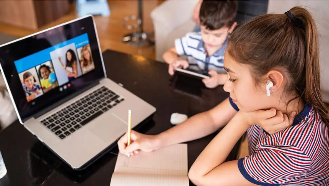 Child studying online school laptop