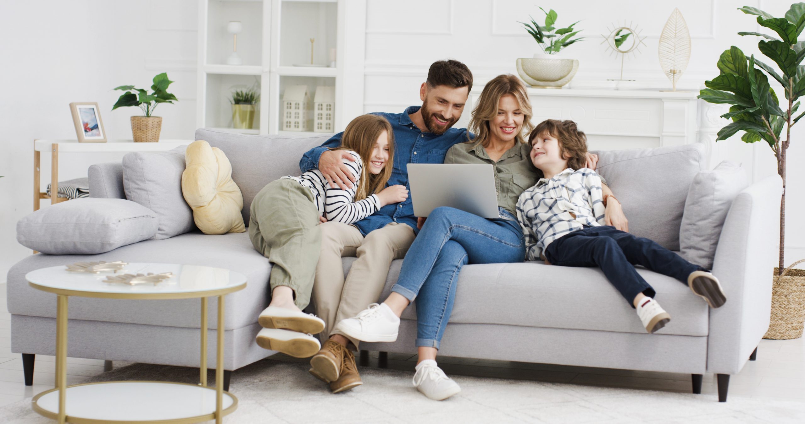 Caucasian,Parents,With,Kids,On,Couch,Using,Gadget.,Young,Man